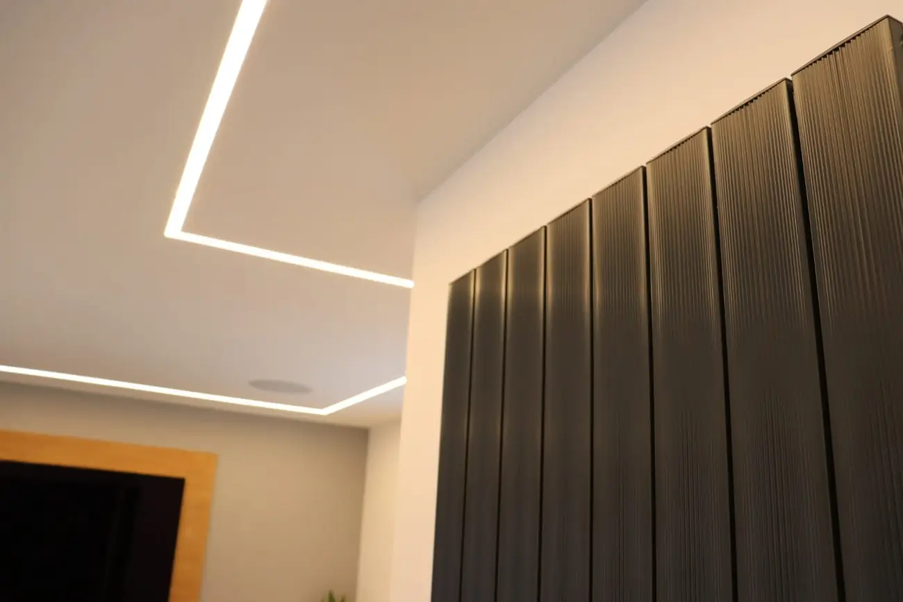 Recessed ceiling lighting beside a fluted feature wall panel
