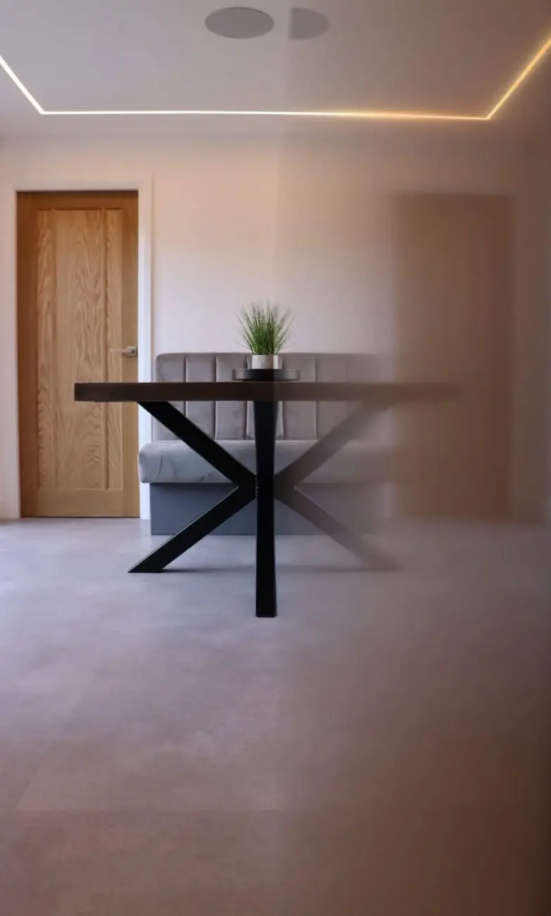 Built-in dining nook with banquette seating and black X-frame table