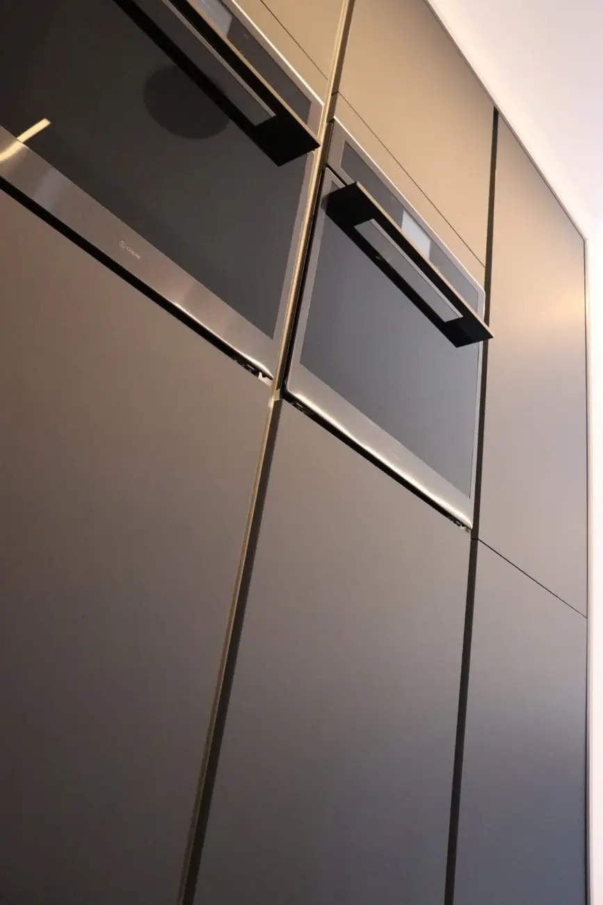 Integrated Caple ovens set into anthracite cabinetry