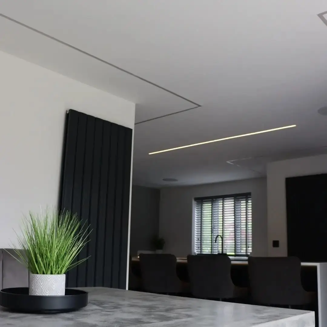 Open-plan kitchen and dining area with black vertical radiator